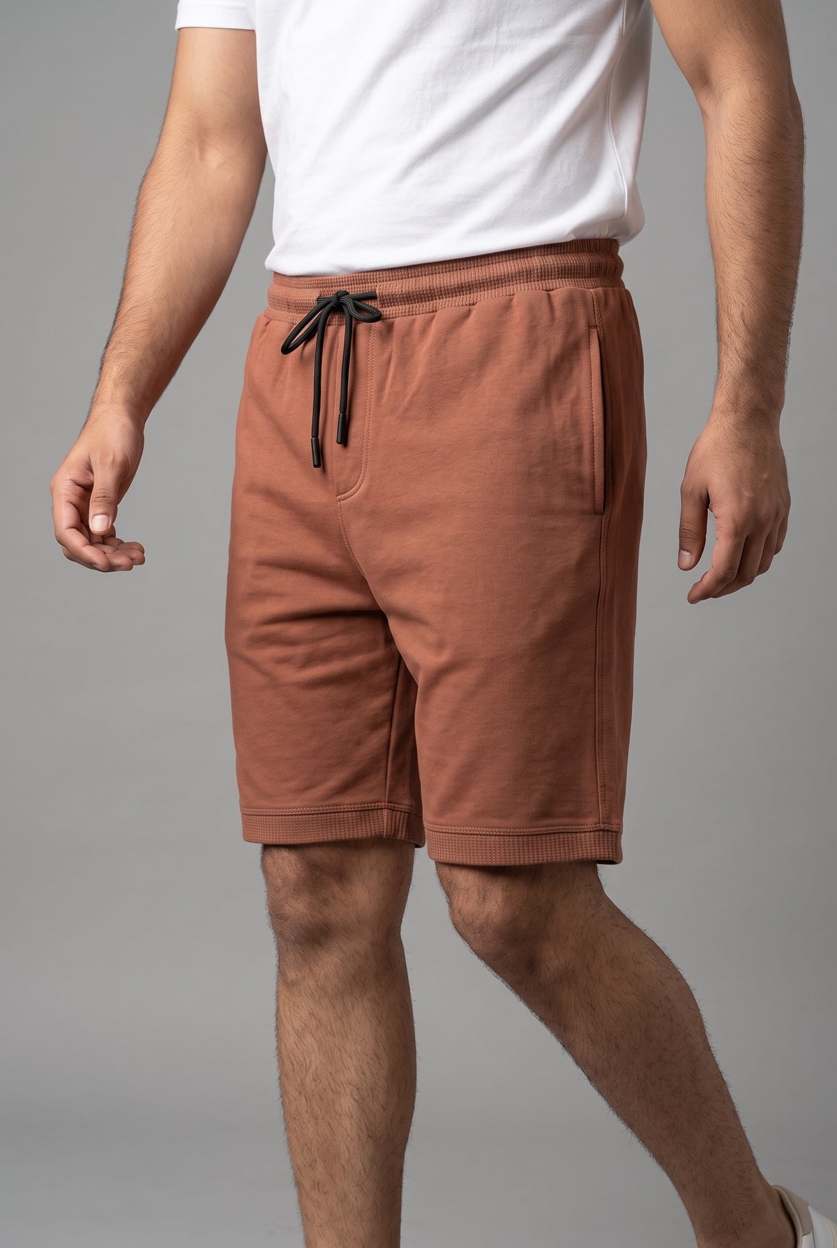 Front view of model wearing Zuke Lifestyle Rust brown knee-length casual sweat shorts
