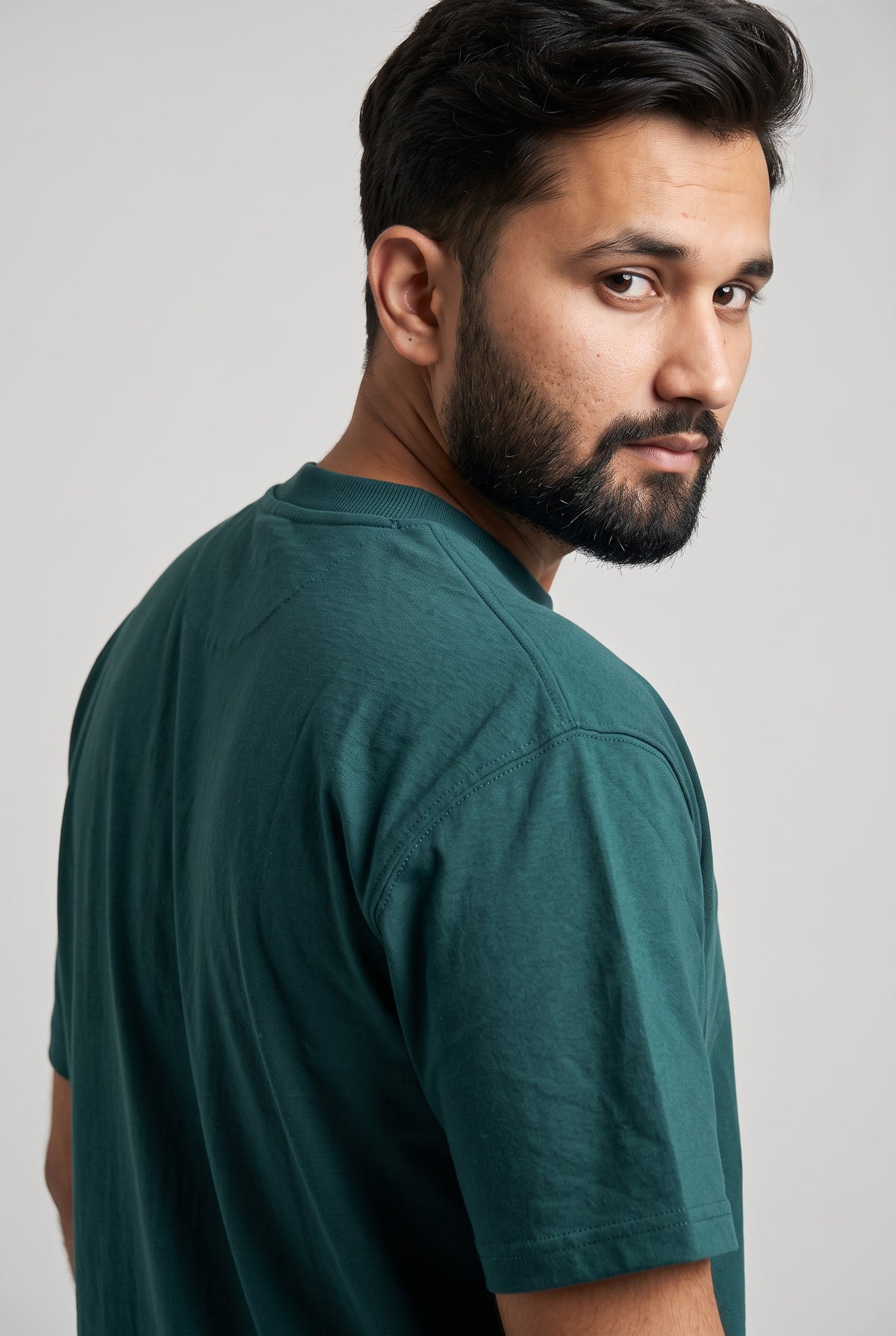 Back view of model wearing Zuke Lifestyle Bottle green t-shirt with The Band graphic